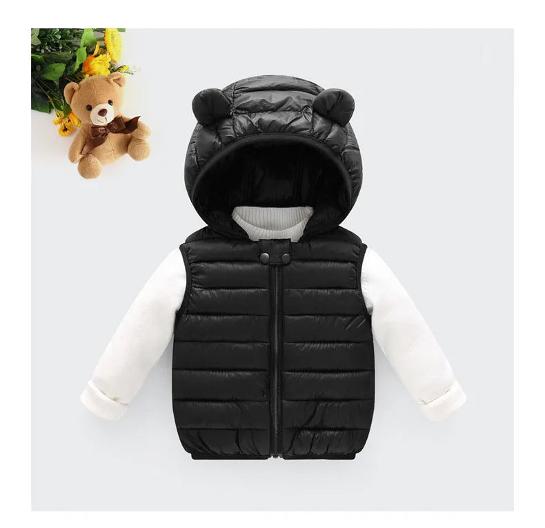 A black quilted hooded vest worn by a teddy bear.