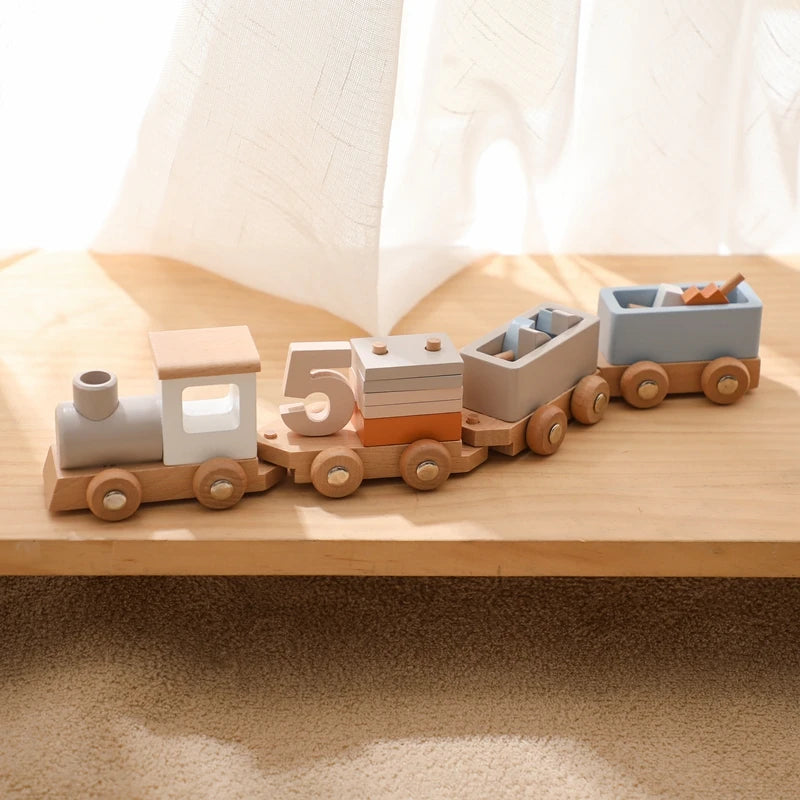 A wooden train set with five numbered cars in various pastel colors on a light wooden surface.