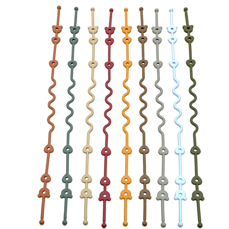 A collection of silicone pacifier clips with anti-drop chains in various colors including orange, red, green, and blue.