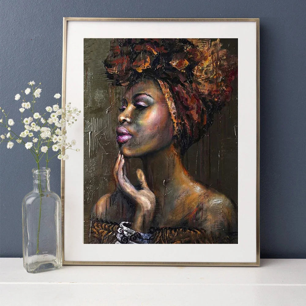 A framed painting of an African woman's portrait with rich, textured skin tones and intricate hair.