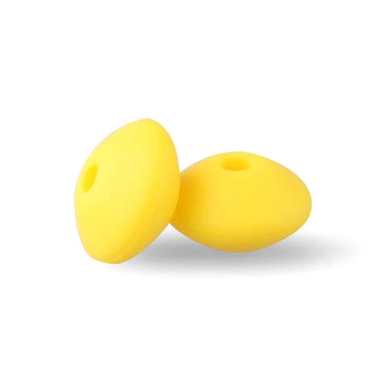 Two yellow silicone lentil beads shaped like an abacus for jewelry making