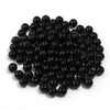 A pile of small, round, black imitation pearl beads for jewelry making.