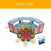 Wooden train track accessories set featuring airport and gas station scenes with various colored tracks and buildings