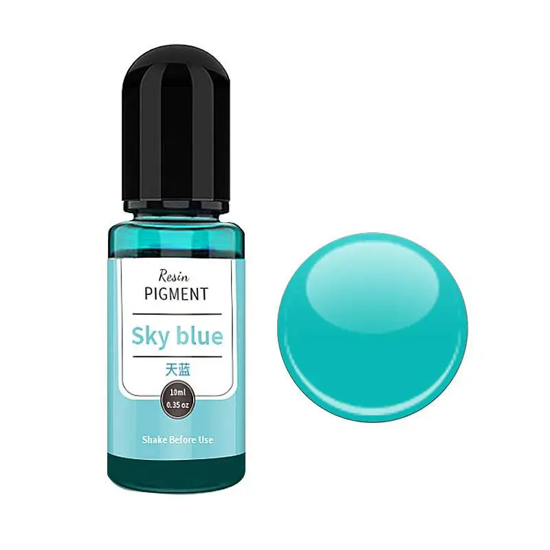A small glass bottle of Sky blue resin pigment with a black cap and a large, round teal bead.