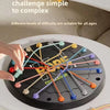 A hand is manipulating a black puzzle board with colored ropes to create a tangle challenge for kids.