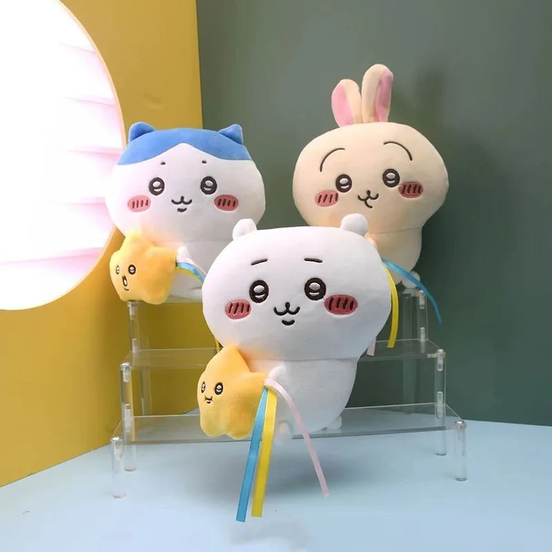 A collection of three soft, cute Chiikawa Usagi plush toys displayed on a clear acrylic stand.
