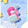 A pink and blue plush figure of a pony sleeping, packaged as a blind box collectible.