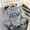 A gray crewneck cotton pullover sweatshirt displayed on a wooden hanger.
