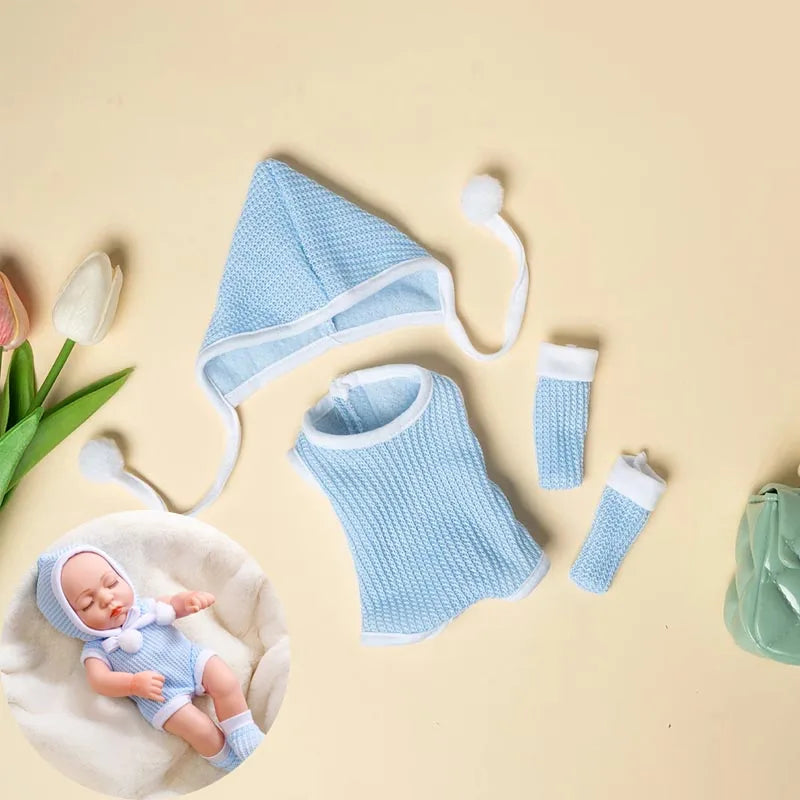 Light blue knitted jumpsuit outfit for a baby doll displayed on a beige background.