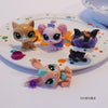 Three small, stylized animal figures in various colors and styles displayed on a white plate.