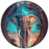 A circular jigsaw puzzle featuring an elephant silhouette against a starry night sky and tree branches.