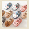 A collection of adorable cartoon bear baby booties in various soft colors and textures for infants.