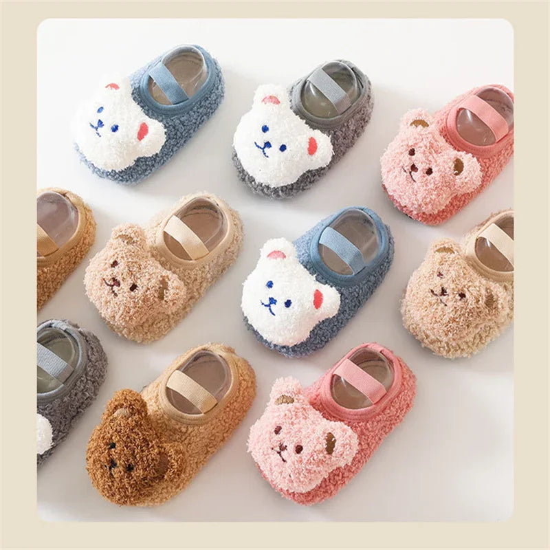 A collection of adorable cartoon bear baby booties in various soft colors and textures for infants.