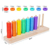 A wooden ring toss game featuring colorful rings in red, orange, yellow, green, and blue, stacked on a wooden board.