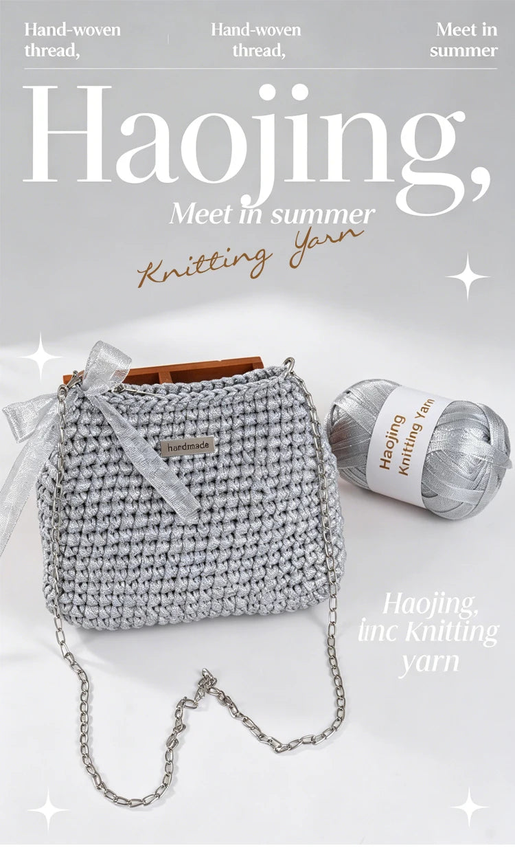 A gray hand-knitted yarn bag with a chain strap is shown next to a ball of matching yarn.