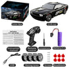 A black high-speed 4WD drift RC car with its remote control, accessories, and instruction manual.