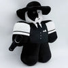 A black and white plush rabbit stuffed toy with a wide-brimmed hat and a collared shirt.