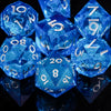 A collection of bright blue polyhedral dice reflecting on a dark surface.