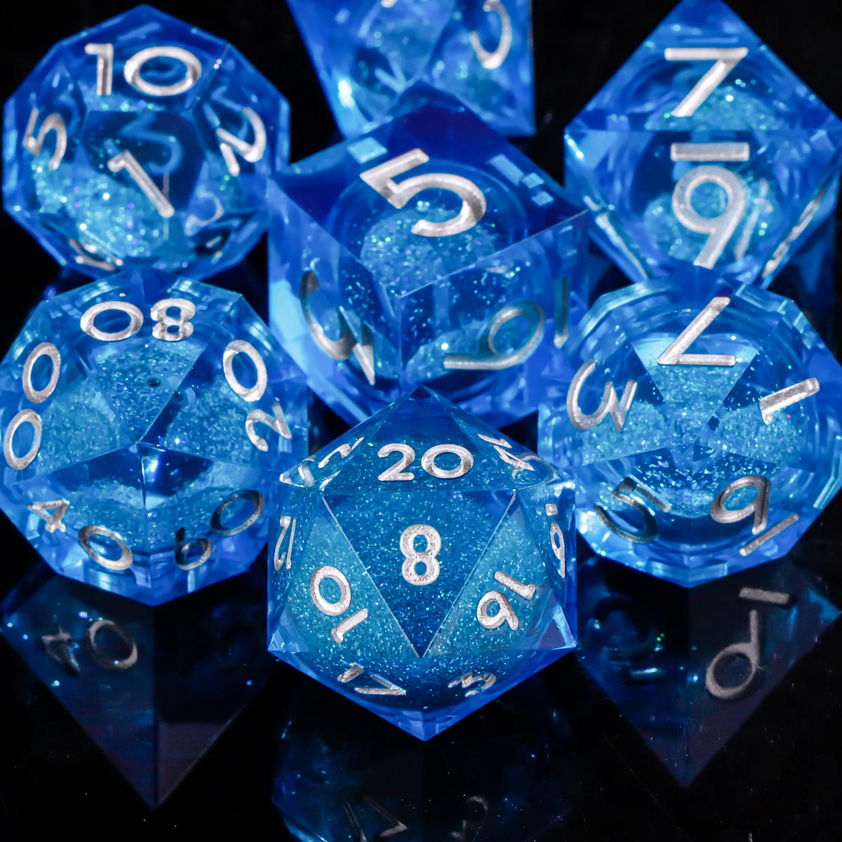 A collection of bright blue polyhedral dice reflecting on a dark surface.