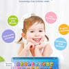 A young girl smiles while interacting with an educational tablet displaying letters, numbers, and buttons for learning.