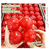 A hand holds a red watermelon slush squeeze ball product with a mixed ice slush texture.