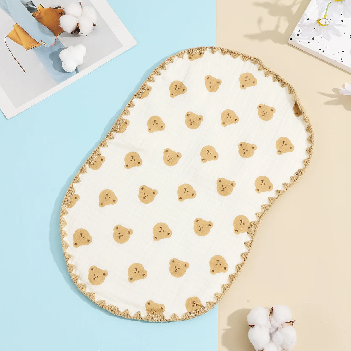 A cream-colored flat pillow decorated with small tan bear shapes on a light blue background.
