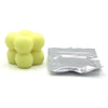 A pile of yellow candle dye chips for soy wax, beeswax, and paraffin wax.