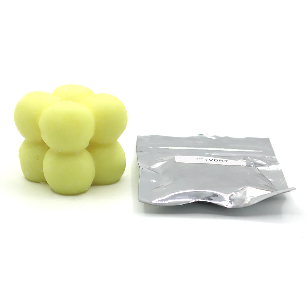 A pile of yellow candle dye chips for soy wax, beeswax, and paraffin wax.