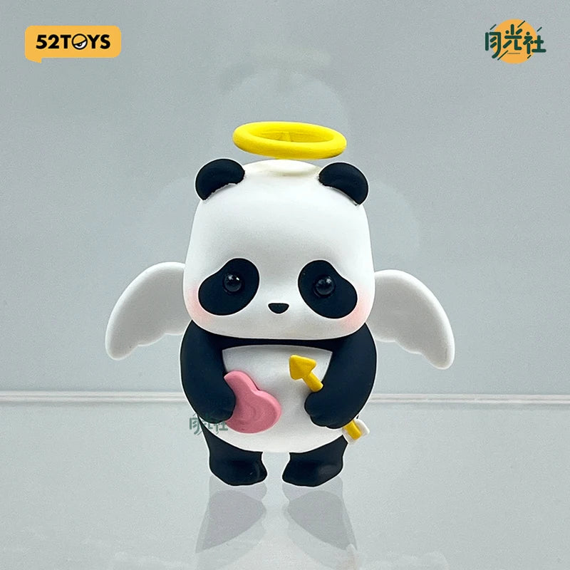 A white and black panda collectible figure with a yellow crown and a pink accessory.
