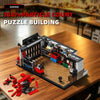 A detailed puzzle building set of a garage structure made from black, red, and gray blocks on a wooden table.