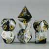 A set of acrylic dice showing numbers 1 through 6, featuring a black and white marbled design.