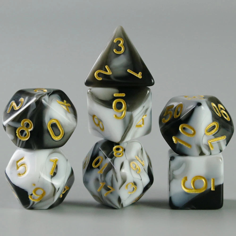 A set of acrylic dice showing numbers 1 through 6, featuring a black and white marbled design.