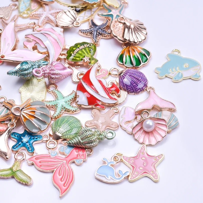 Assortment of gold-tone enamel charms featuring sea creatures and starfish for jewelry making