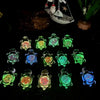 A collection of glow-in-the-dark mini sea turtle figurines in various shades of green, blue, and yellow.