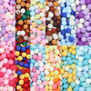A colorful assortment of matte acrylic beads in various shades including pink, orange, blue, and yellow.