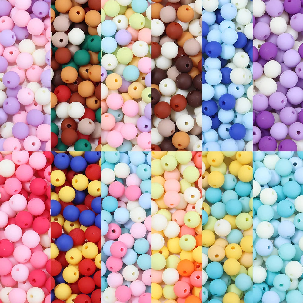 A colorful assortment of matte acrylic beads in various shades including pink, orange, blue, and yellow.