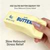 A hand holds a yellow salted butter squishy toy for stress relief.