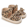 Pair of leopard print soft sole baby sneakers with fabric bow details.