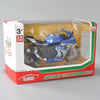 A diecast model of a blue and black Suzuki GSX-R1000R motorcycle is displayed in its original packaging.