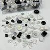 A collection of mixed clear, black, and white acrylic bow and flower beads for jewelry making.