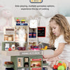 A child plays with a detailed home kitchen pretend play set featuring cooking tools and food items.