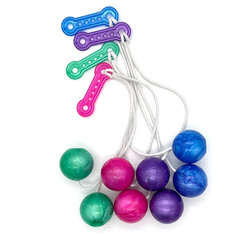 A collection of colorful click clack stress relief fidget balls strung together on a white cord.