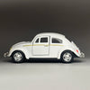 A white diecast model of a classic retro Beetle with gold accents, shown in profile view.