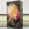 A black box containing the Lune de l'Univers Tarot deck, featuring a mystical design with gold and pink tones.