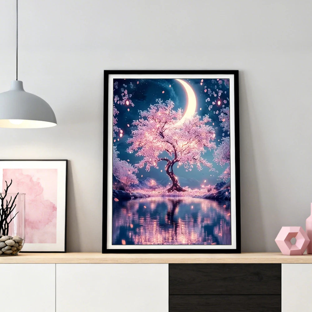 A framed painting featuring a pink and purple moonlit tree landscape with a reflection on water.