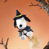 A collectible figure of Snoopy Mischief Party Series dressed as a wizard with a black hat and blue outfit, perched on a tree 