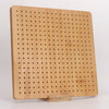 A light wood bamboo crochet blocking board with numerous small holes and a wooden stand.