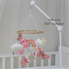 Handmade felt butterfly crib mobile with clouds and a rainbow hanging from a white crib arm.