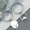 Silver keychain featuring an anime-inspired face charm and a circular ring.