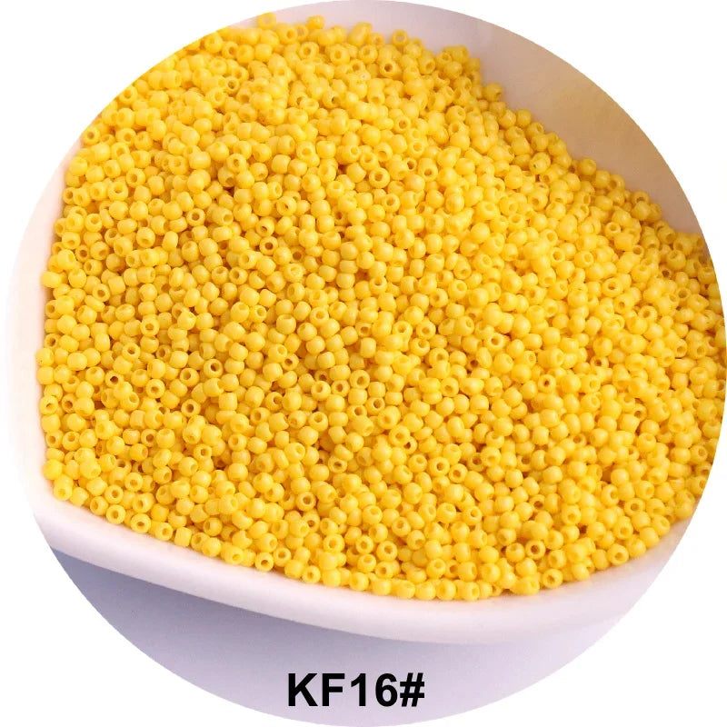 A pile of yellow seed beads is shown in a white bowl.